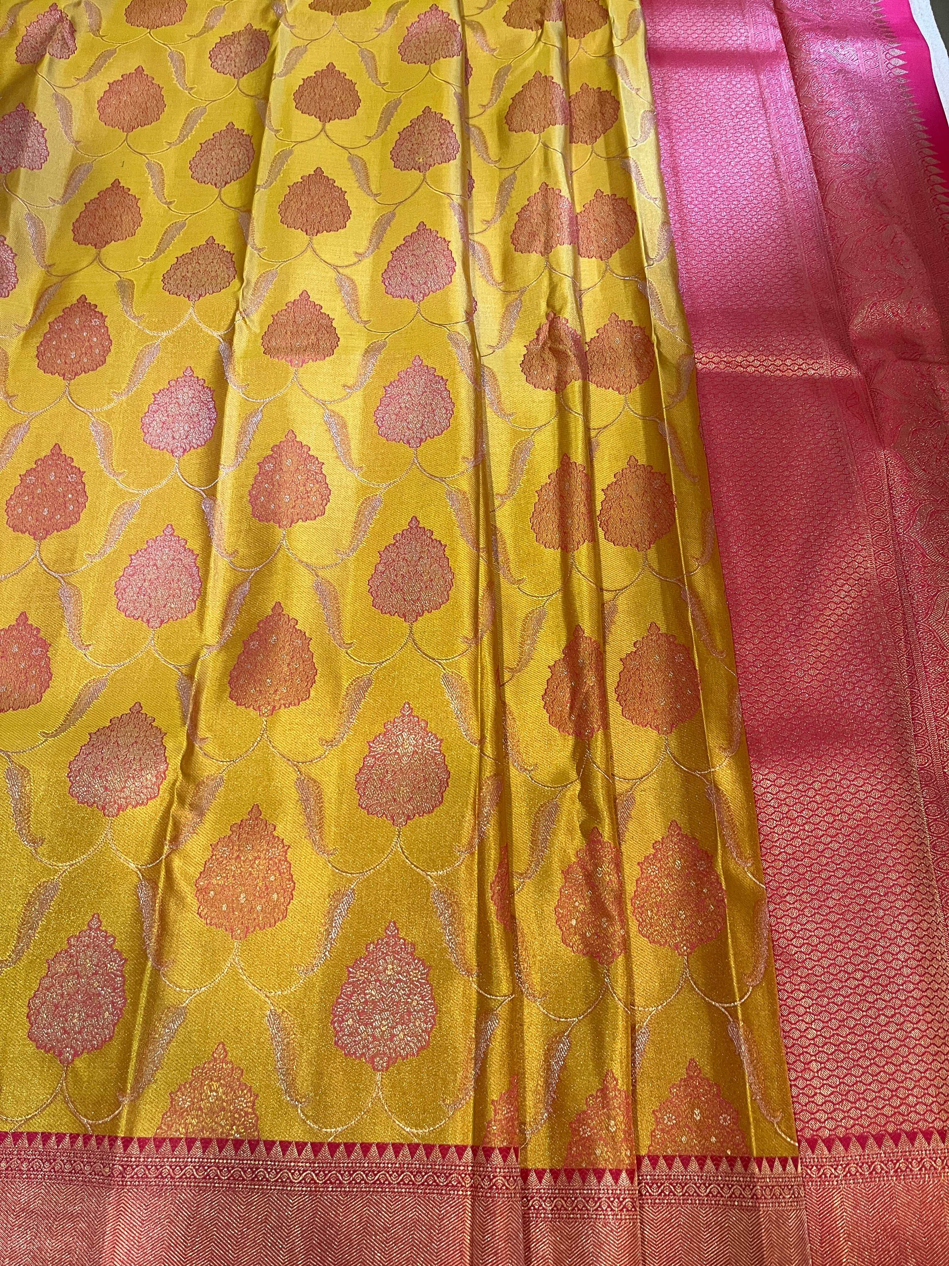 Bavanji border Illuminating yellow with rouge pink floral patterns on a jaali body Kanjivaram silk Saree