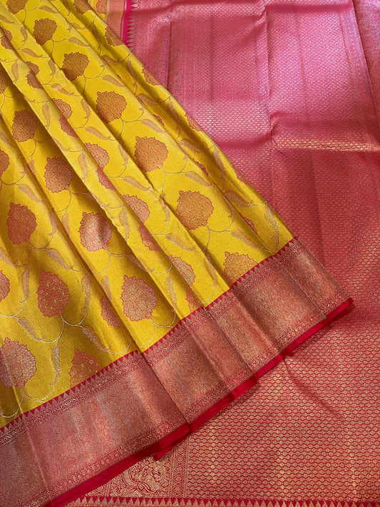 Bavanji border Illuminating yellow with rouge pink floral patterns on a jaali body Kanjivaram silk Saree